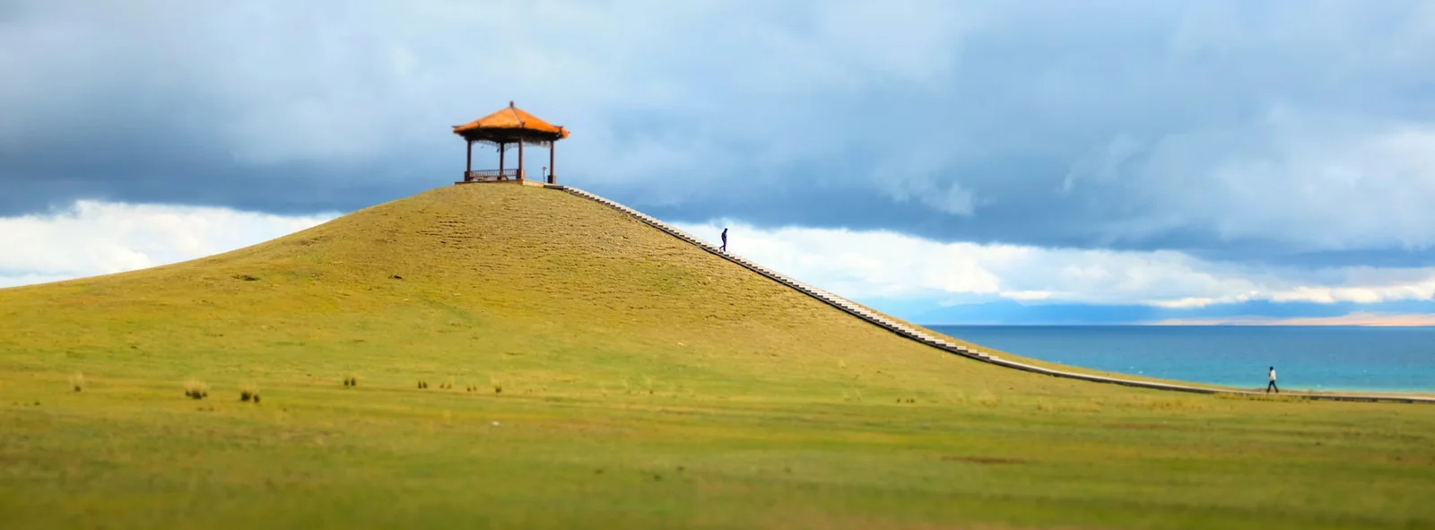 A pavilion and hillside beside Sayram Lake