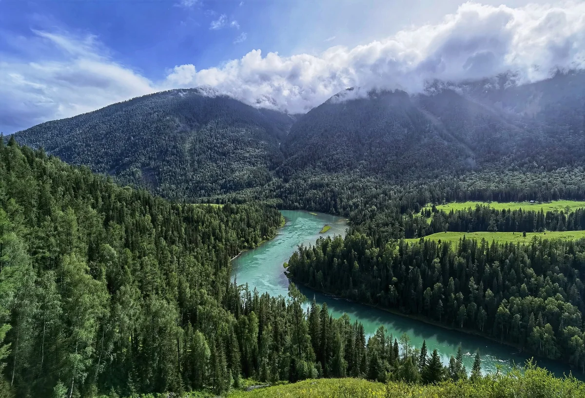 Moon Bay’s turquoise curve winds through the forests of Kanas.