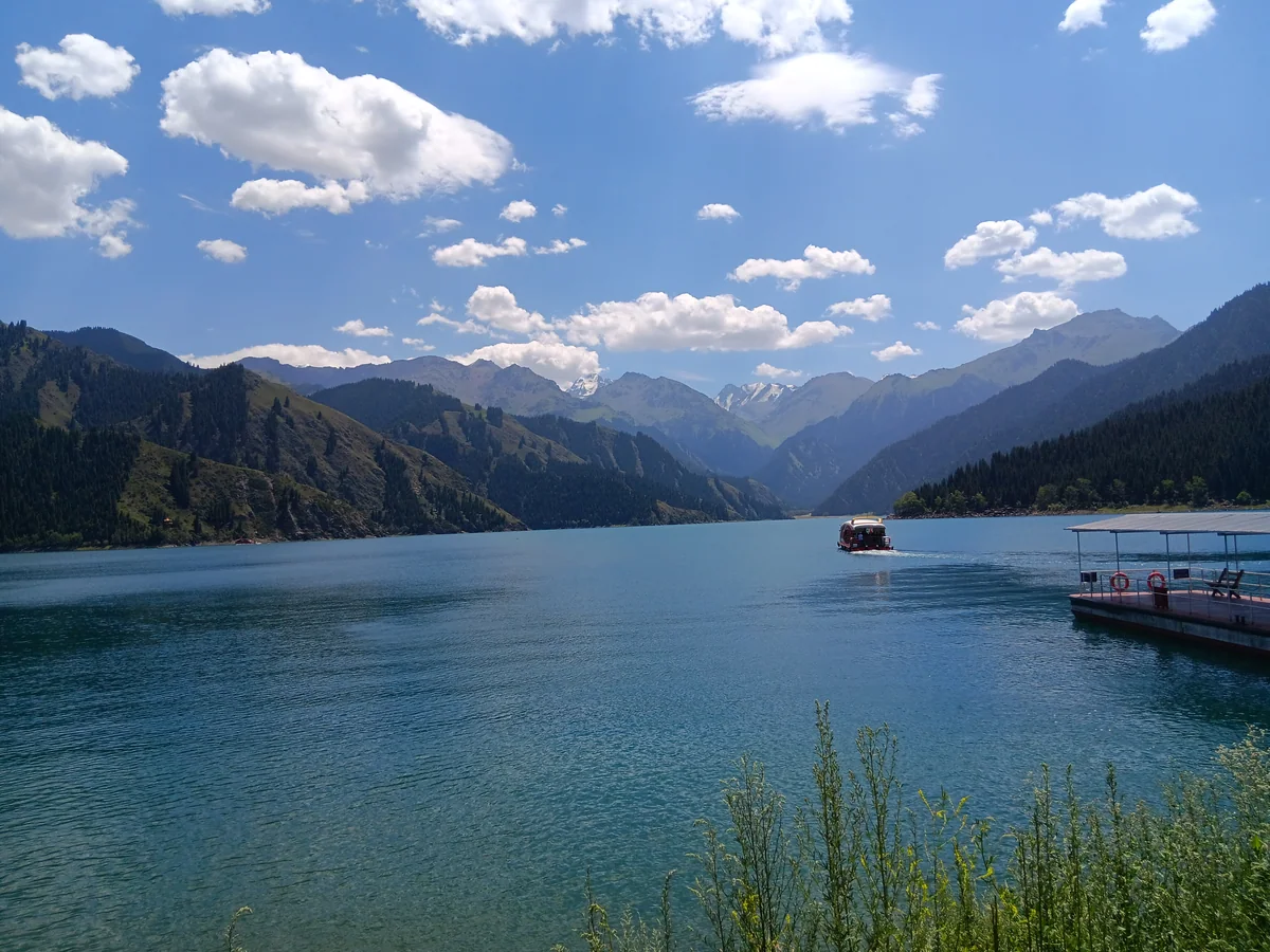 Mountain ridges and drifting clouds surround Tian Shan’s Heavenly Lake.