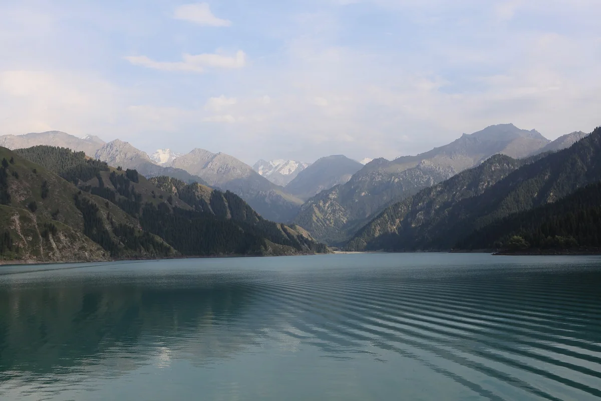 Ripples lead towards the mountains across Tian Shan’s Heavenly Lake.