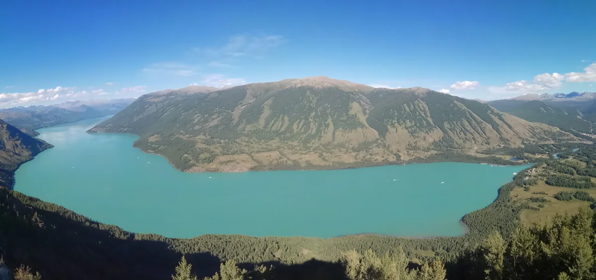 An elevated panorama reveals the sweep of Kanas Lake.