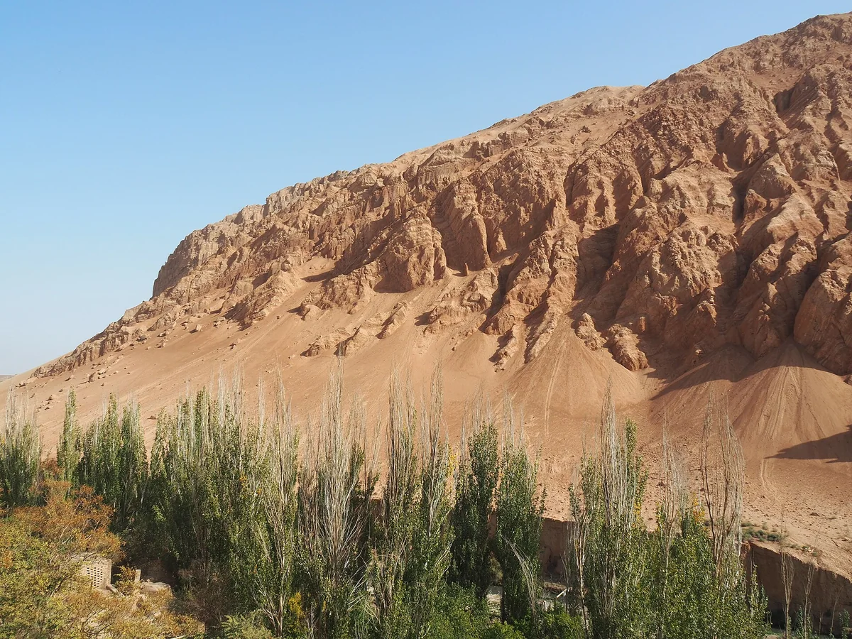The red ridges of Turpan’s Flaming Mountains meet a ribbon of green.