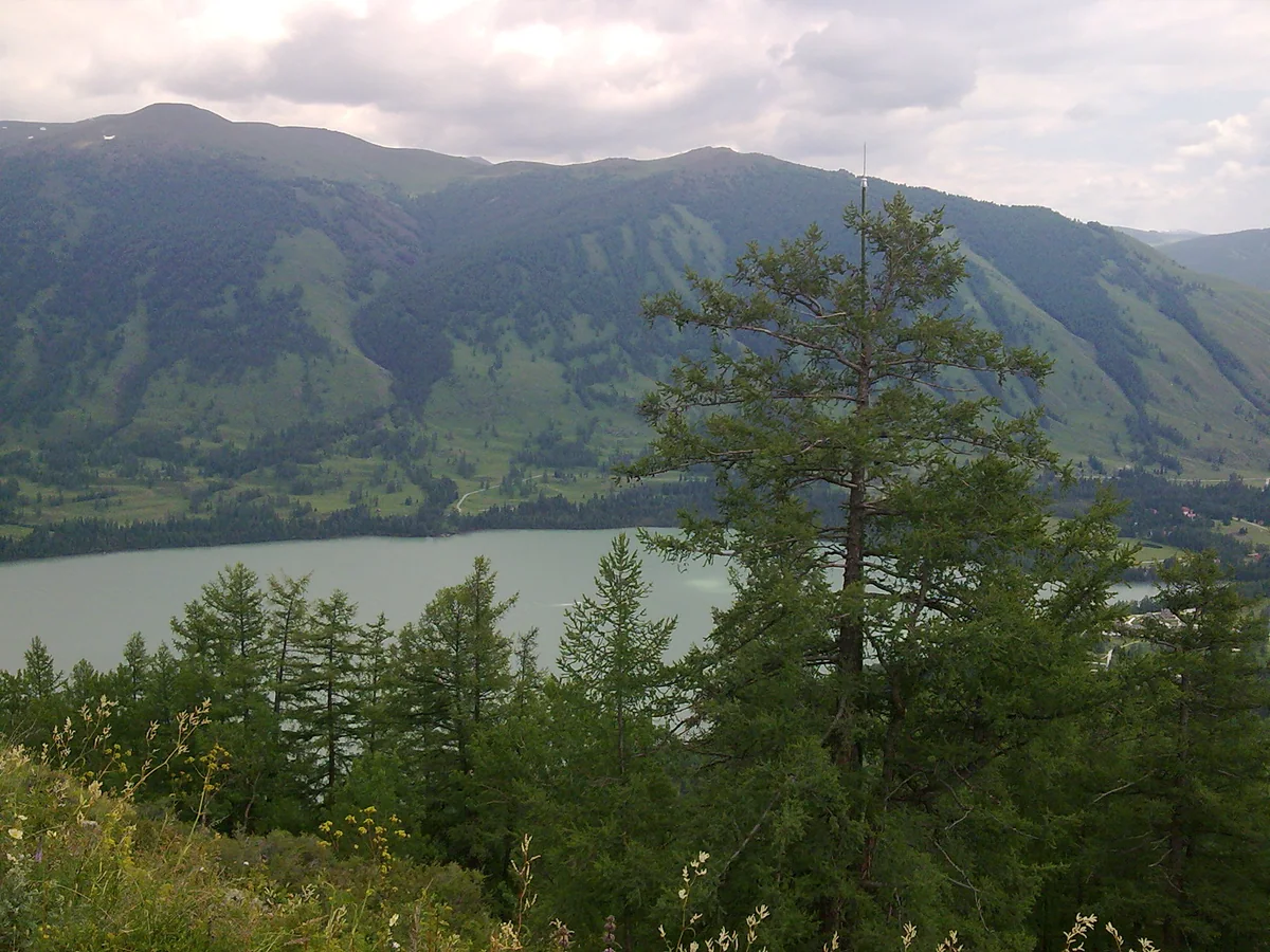 Shifting light brings depth to the mountains beside Kanas Lake.
