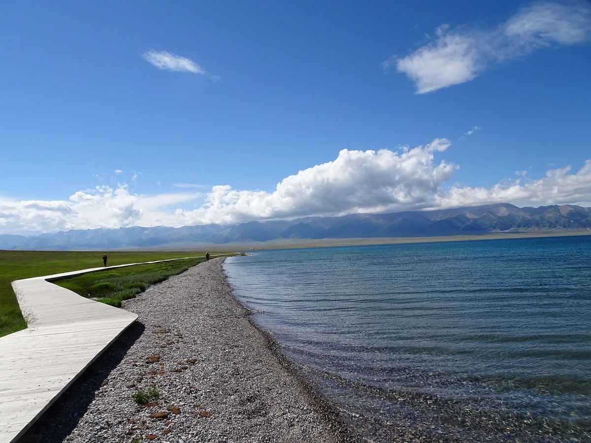 A lakeside boardwalk offers a slower perspective on Sayram Lake.