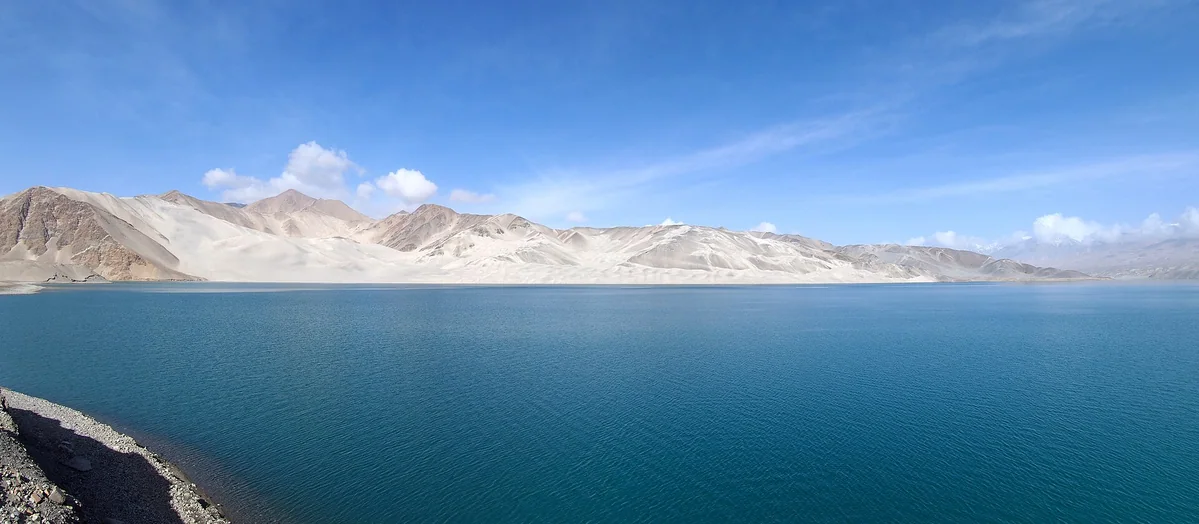 Pamir’s White Sand Lake, framed by pale sand mountains.