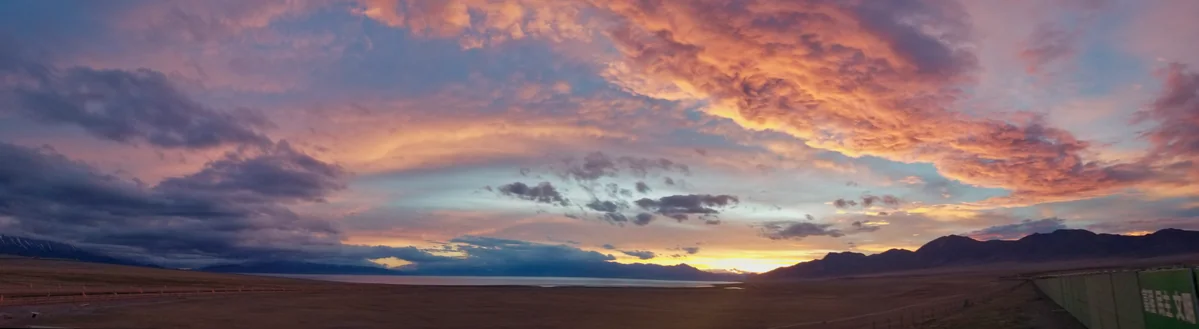 A sunset panorama of Sayram Lake; light and weather make every visit different.